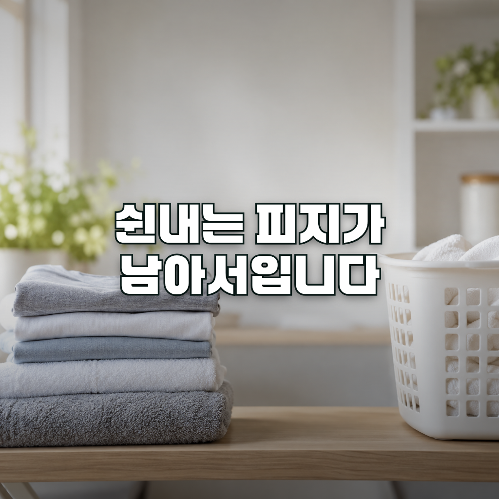 A neatly folded stack of clean cotton t-shirts and towels sitting on a light wooden shelf beside a white laundry basket,