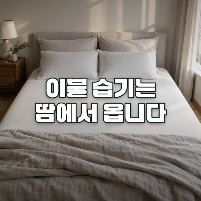 A quiet bedroom in soft morning light, with a duvet folded back toward the foot of the bed and a plain mattress surface